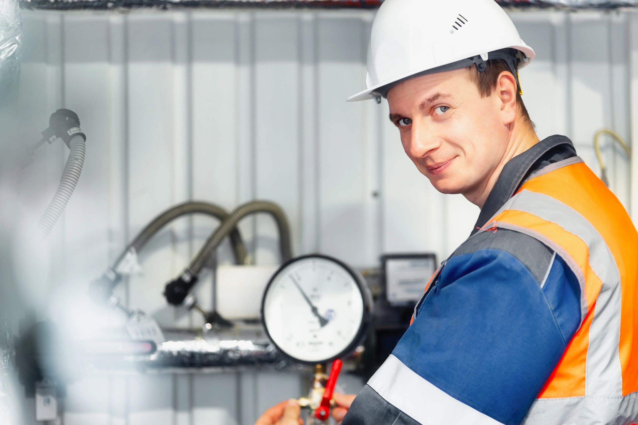 Maintenance operator in safety helmet in an equipment room